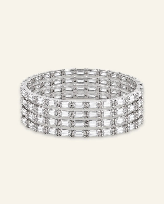 Elegant Rhinestone Bracelet, a stacked set of four silver-tone metal bangles densely set with alternating baguette-cut stones and shining stone accents against a clean neutral background.