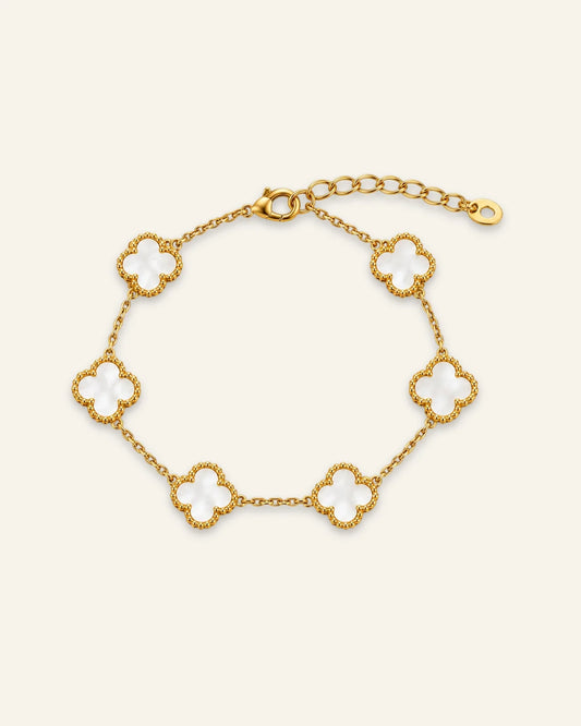 Floral Emblem Bracelet featuring white floral motifs with gold-tone detailing and a delicate chain.