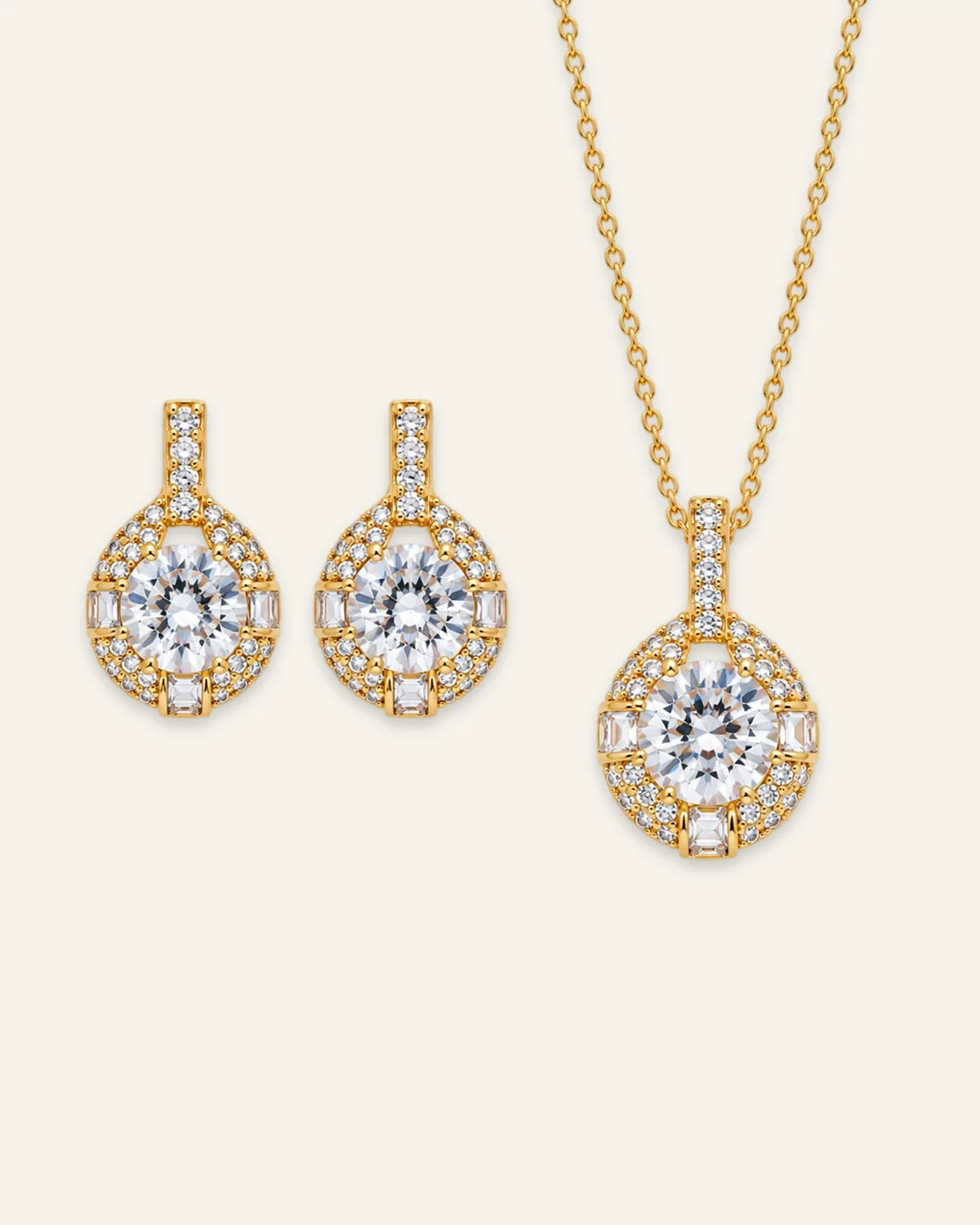 Gold halo pendant necklace and matching drop earrings set featuring round brilliant clear gemstones with pave and baguette accents.