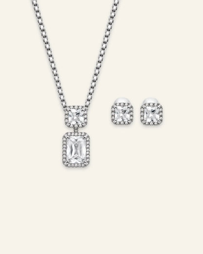 Regalia gemstone jewelry set featuring a silver-tone pendant necklace and matching stud earrings with emerald-cut clear center stones and crystal halos