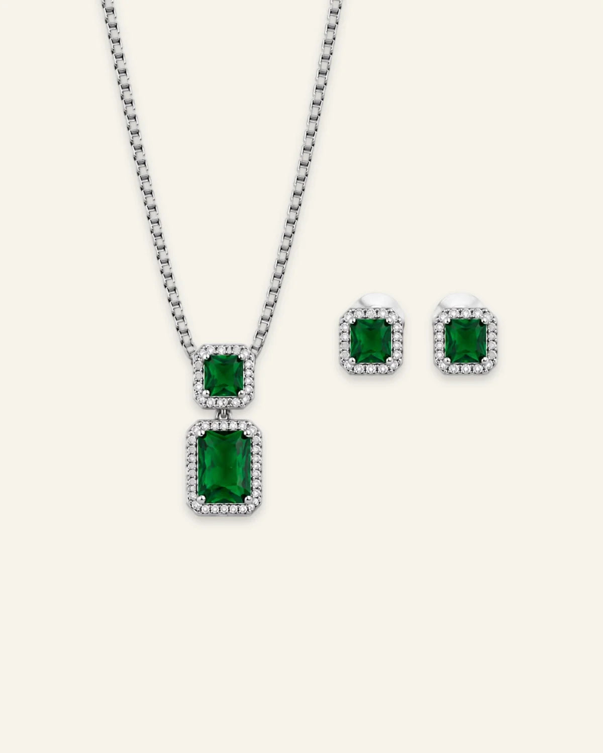 Regalia gemstone jewelry set featuring a silver-tone pendant necklace and matching stud earrings with emerald-cut green center stones and clear crystal halos.