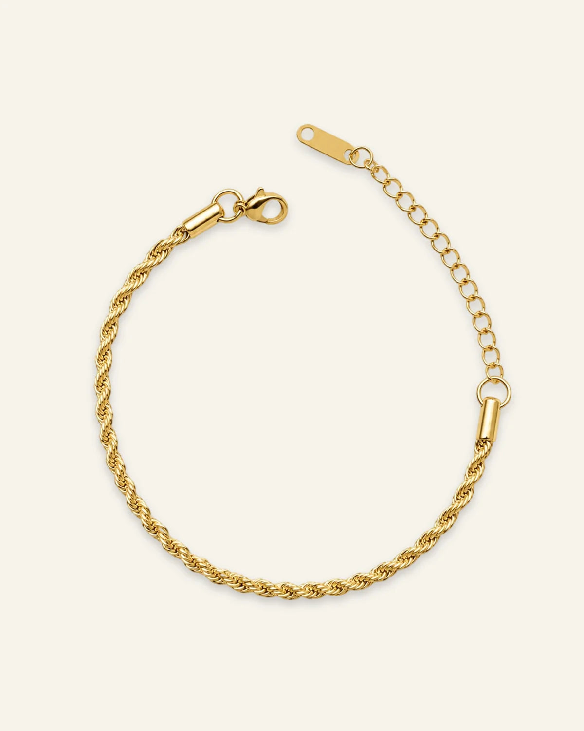 A gold-toned twisted rope chain bracelet with a lobster clasp and extension chain, displayed on a light cream background.