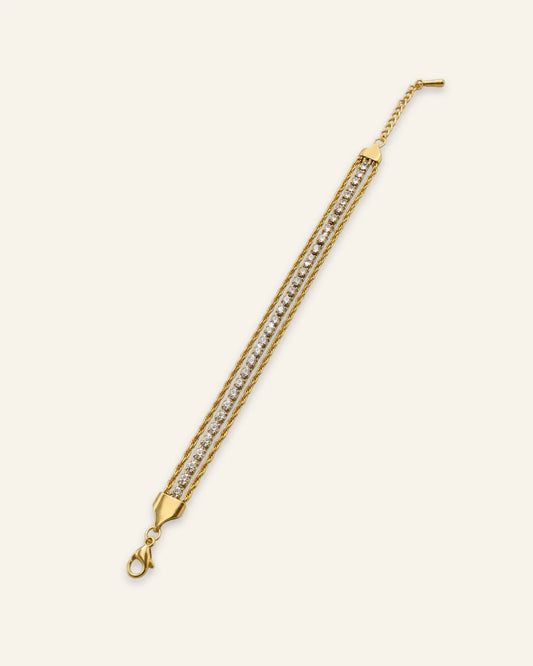 Celeste Crystal Wrap Bracelet, a multi-strand gold-tone bracelet featuring central rows of shining stones flanked by twisted chains, an adjustable clasp extension on a neutral background.