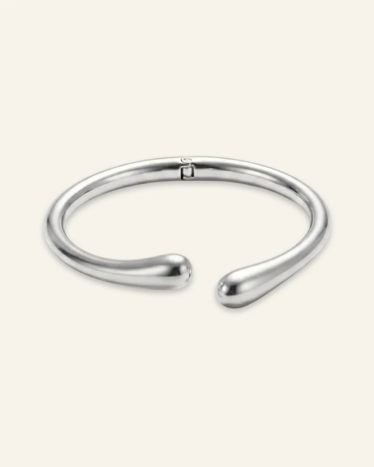 Duo Curve Bracelet, an open silver-tone metal cuff featuring smooth, teardrop-shaped terminals and a hinged closure, displayed on a clean neutral background.