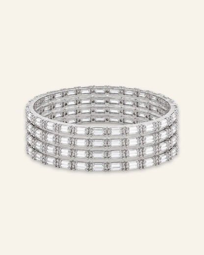 Elegant Rhinestone Bracelet, a stacked set of four silver-tone metal bangles densely set with alternating baguette-cut stones and shining stone accents against a clean neutral background.