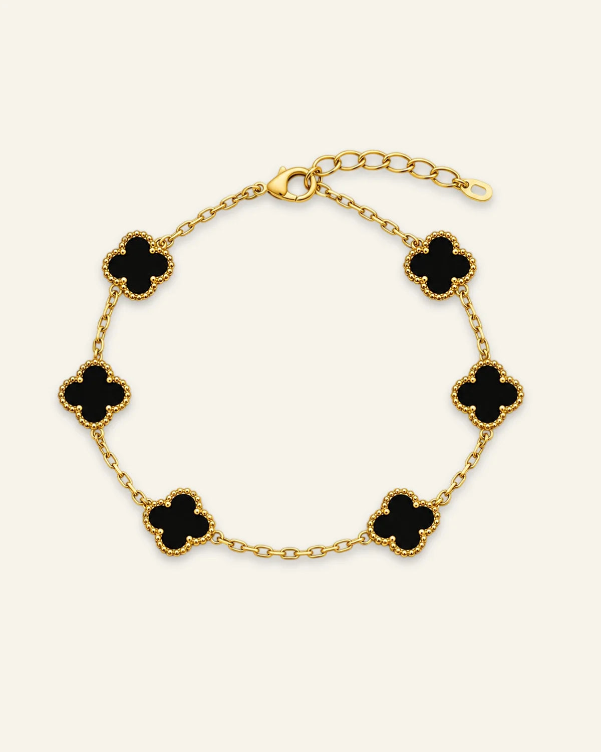 Floral Emblem Bracelet featuring black floral motifs with gold-tone detailing and a delicate chain.