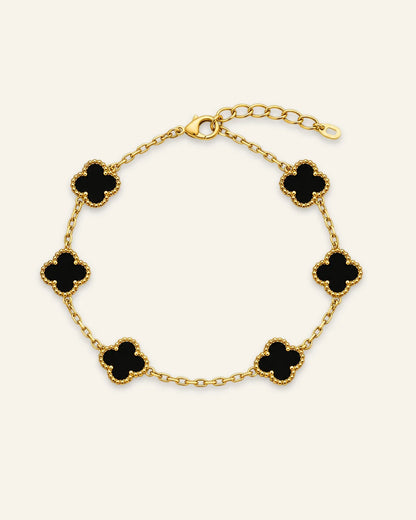 Floral Emblem Bracelet featuring black floral motifs with gold-tone detailing and a delicate chain.