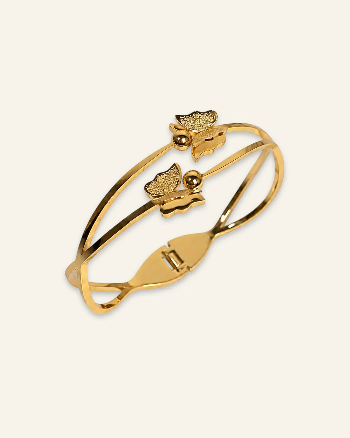 Golden Flutter Butterfly Bracelet, a polished gold-tone double-band hinged bangle featuring two textured butterfly motifs with central spherical accents against a clean neutral background.