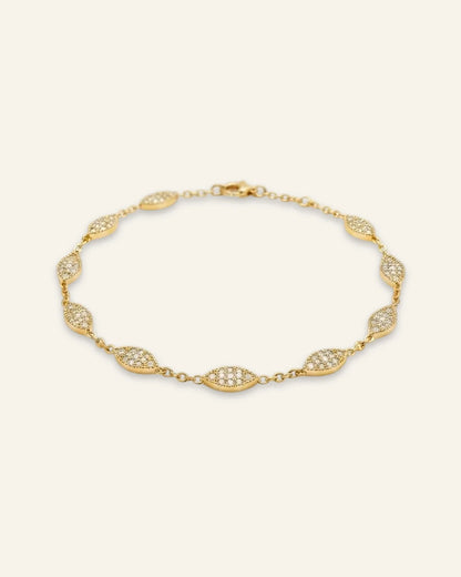 Minimalist Marquise Charm Bracelet, a delicate gold-tone chain bracelet featuring spaced marquise-shaped stations densely set with shining pave stones against a clean neutral background.