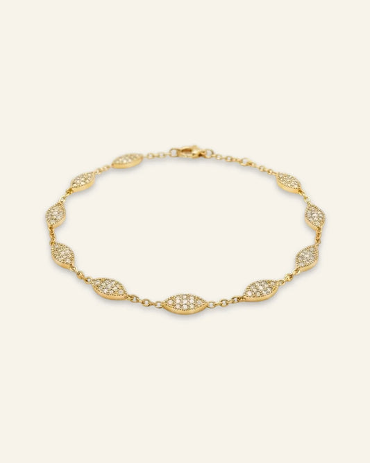 Minimalist Marquise Charm Bracelet, a delicate gold-tone chain bracelet featuring spaced marquise-shaped stations densely set with shining pave stones against a clean neutral background.