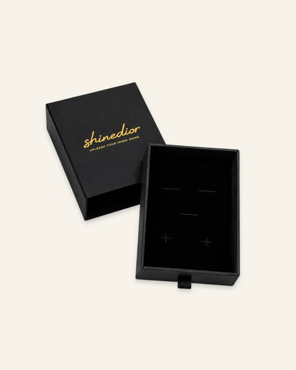 Shinedior luxury black drawer jewelry box showing outer gold foil stamped sleeve and black velvet insert tray on a clean white backdrop.